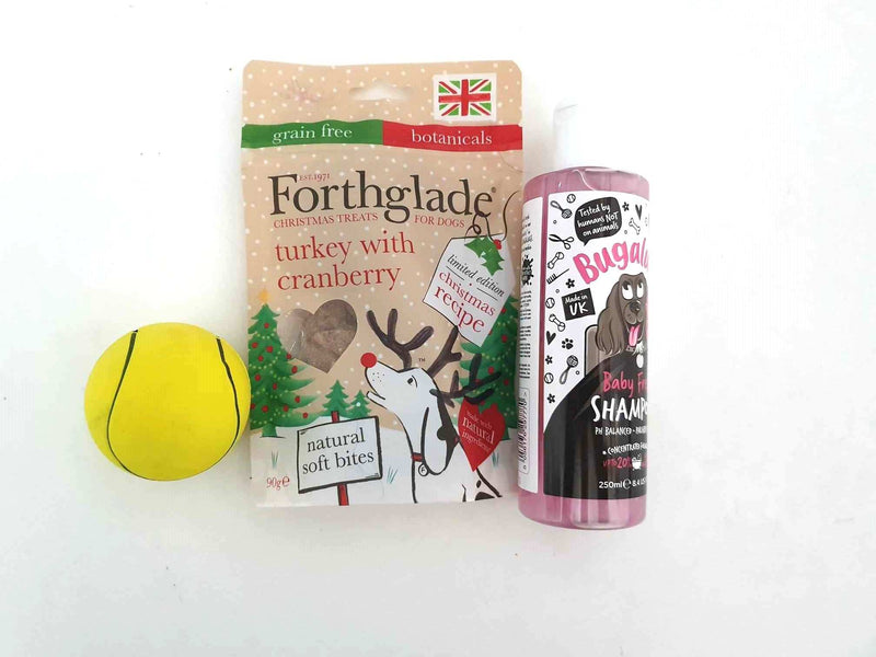 Gift Wrapped Christmas Bundles for pets with treats, shampoo, and toy ball.