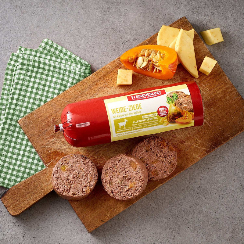Meatlove Pasture Raised Goat Single Protein Food Rolls for Dogs with pumpkin and Swedes, 800g chub on a cutting board.