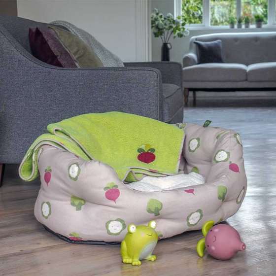 Veggie Oval Dog Bed with sheep design on light blue background, featuring deep-filled sides and reversible cushion.