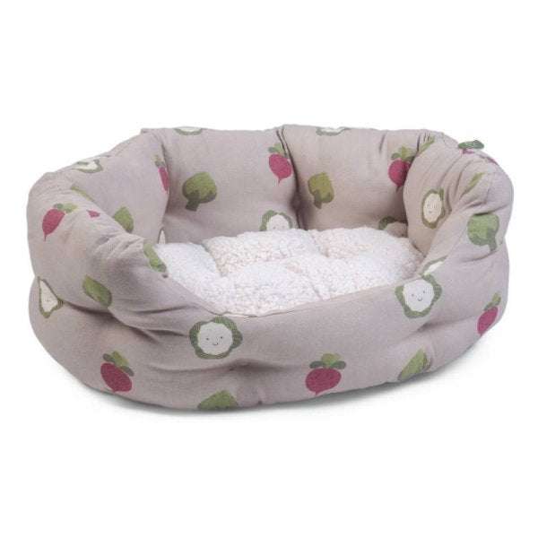 Veggie Oval Dog Bed with sheep pattern on cream fabric, high sides, and reversible inner cushion.