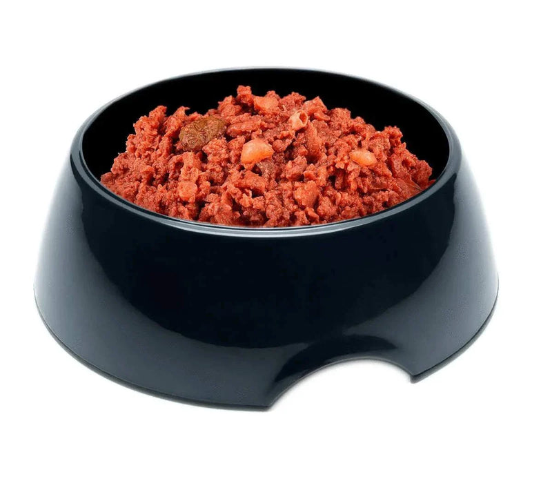 Kitten food pouches with chicken in a black bowl.