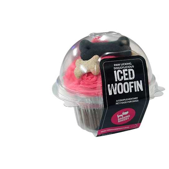 Barking Bakery Iced Woofin Dog Treat in recyclable packaging with pink icing and bone decoration.