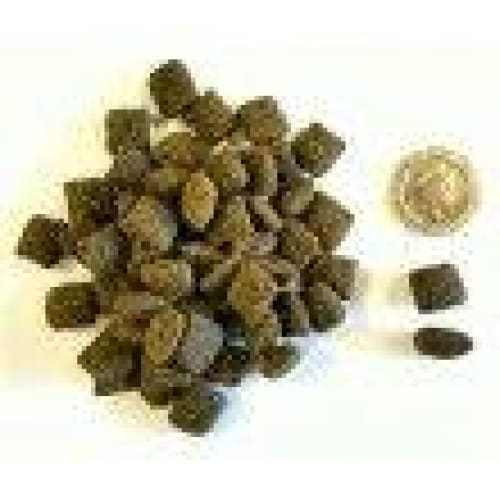Eden Semi-Moist Country Feast Dog Food pellets with coin for size comparison.