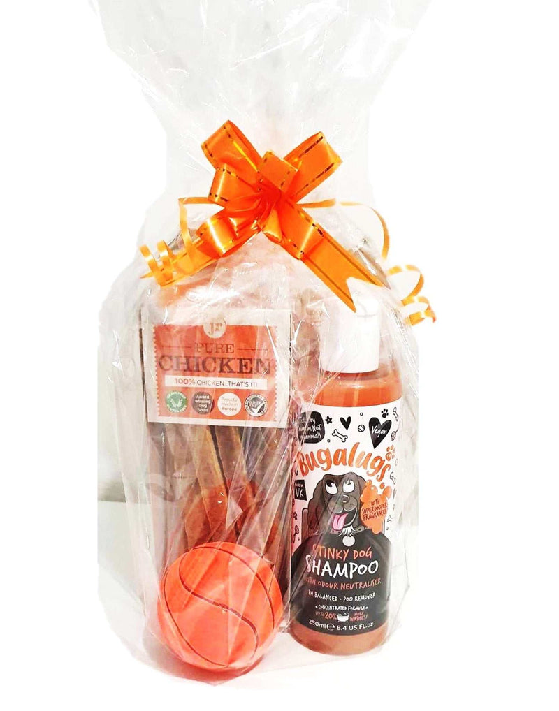 Gift wrapped Christmas bundles for pets featuring treats and hygiene products tied with an orange ribbon.