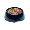 Symply Duck & Turkey Wet Dog Food in black bowl with herbs and vegetables