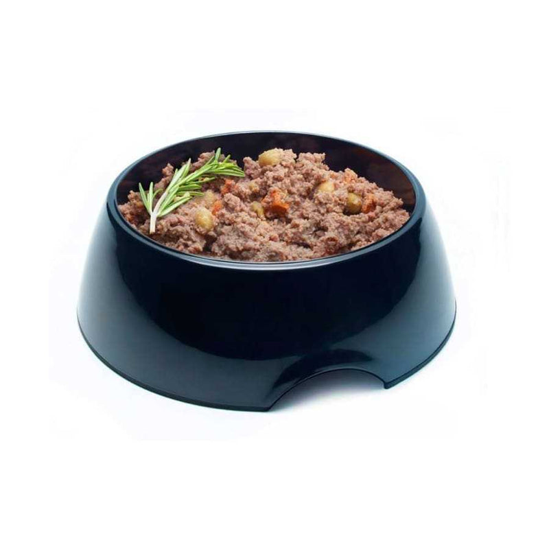 Symply Duck & Turkey Wet Dog Food in black bowl with herbs and vegetables