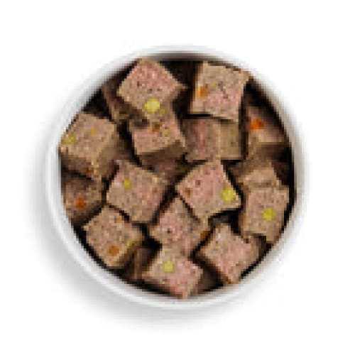 Turkey, sweet potato, and vegetable wet dog food cubes in a bowl.